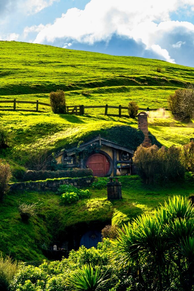Scenic view of Hobbit House in sunny fields of Matamata, New Zealand's iconic Hobbiton