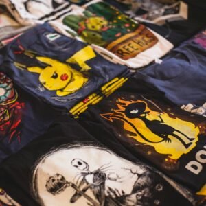 A vibrant assortment of graphic t-shirts featuring popular characters displayed in a market setting.