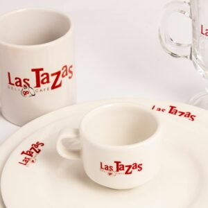 Beautiful white tableware set with Las Tazas Café branding, perfect for elegant dining.