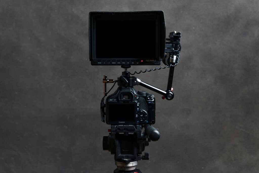 High-quality video camera with attached monitor and tripod, ideal for filming.