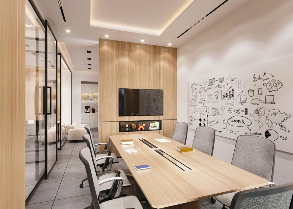 Sleek conference room featuring a large table, chairs, TV, and brainstorming whiteboard.